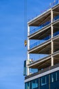 BELLEVUE, USA â MAY 3, 2023: Spring District, under construction, crane loading in new window to workers ready to install