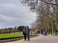 Group of people walking around in the park in downtown Bellevue near the ice rink, the city skyline in the background Royalty Free Stock Photo