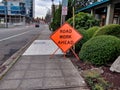 Orange Road Work Ahead sign before the Bellevue Way and NE 2nd Street construction sites in downtown near the park