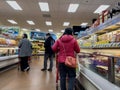 Bellevue, WA USA - circa December 2022: Wide view of people shopping in the frozen food section of a Trader Joes grocery store Royalty Free Stock Photo