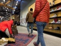 Bellevue, WA USA - circa December 2022: Wide view of people shopping for hiking boots and other outdoor shoes inside an REI store