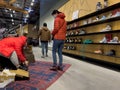 Bellevue, WA USA - circa December 2022: Wide view of people shopping for hiking boots and other outdoor shoes inside an REI store