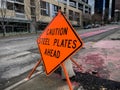 Bellevue, WA USA - circa February 2023: close up view of a Caution Steel Plates Ahead sign in the downtown area around a