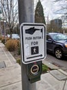 Selective focus on a `push button to cross street` crosswalk sign in downtown Bellevue Royalty Free Stock Photo