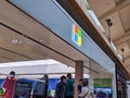 Exterior view of a Microsoft Store entrance as customers enter, shopping for new