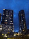 Street view of rush hour traffic and night life starting up in downtown in the late Royalty Free Stock Photo