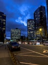 Street view of rush hour traffic and night life starting up in downtown in the late Royalty Free Stock Photo