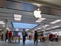 Technology crazed customers shopping inside an Apple store, scoping out iPhones and