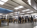 Technology crazed people shopping inside an Apple store for the latest iPhones and