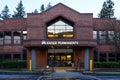 Kaiser Permanente facade with sign at dawn in rain