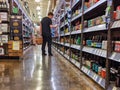 Person shopping for beer and liquor inside a Total Wine and More beverage shop in downtown Bellevue.