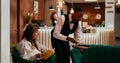 Bellhop serving coffee cup to woman