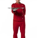 Bellhoper with red uniform presents a tray.