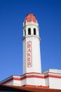 Iconic tower with text at Mount Baker Theatre in red and white with blue sky