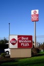 Two red and white Best Western Plus signs outside hotel chain location