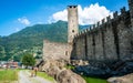 Tourists going to Castelgrande castle and castle view with little pond in Bellinzona Ticino Switzerland