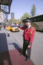 Bellman in red jacket calls for cab in front of Helmsley Park Lane Hotel on Central Park West, in Manhattan, New York City, New Yo Royalty Free Stock Photo