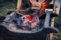 The bellows of the blacksmith fanning the fire in the coals. Evening work at the old forge Royalty Free Stock Photo