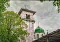 Belltower and dome with cross of small orthodox church against gloomy sky Royalty Free Stock Photo