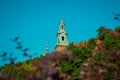 Belltower of Wawel castle in Krakow city, rising up from the green grass up towards the blue sky.. Wide panorama of famous castle Royalty Free Stock Photo