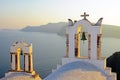 Belltowers at sunset in Oia Royalty Free Stock Photo