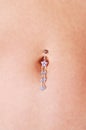 Belly button jewelry. Royalty Free Stock Photo