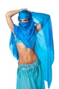Belly dancer peeking from behind a blue veil Royalty Free Stock Photo