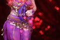 Belly Dancer wearing purple dance costume close up with bokeh Royalty Free Stock Photo