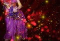 Belly Dancer wearing purple dance costume close up with bokeh Royalty Free Stock Photo