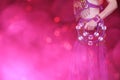 Belly Dancer wearing purple dance costume close up with bokeh Royalty Free Stock Photo