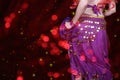 Belly Dancer wearing purple dance costume close up with bokeh Royalty Free Stock Photo