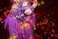 Belly Dancer wearing purple dance costume close up with bokeh Royalty Free Stock Photo