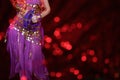 Belly Dancer wearing purple dance costume close up with bokeh Royalty Free Stock Photo