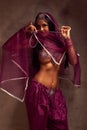 Belly-dancer woman in afghani pants, purdah and adornment Royalty Free Stock Photo