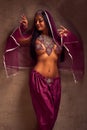 Belly-dancer woman in afghani pants, purdah and adornment Royalty Free Stock Photo