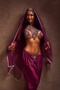 Belly-dancer woman in afghani pants, purdah and adornment Royalty Free Stock Photo