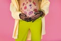 belly with floral ornament, of pregnant girl close-up with hand in lace gloves bright clothes Royalty Free Stock Photo