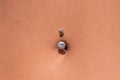 Belly piercing in the navel close up Royalty Free Stock Photo