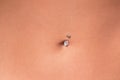 Belly piercing in the navel close up Royalty Free Stock Photo