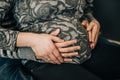 Belly of a pregnant girl with wedding rings Royalty Free Stock Photo