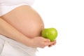 Belly pregnant woman with an apple in profile Royalty Free Stock Photo