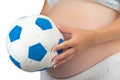 Belly of a pregnant woman with soft toy ball. Royalty Free Stock Photo