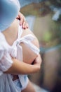 Belly of pregnant woman in white dress Royalty Free Stock Photo