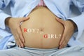 Belly of pregnant women and boy or girl text. Royalty Free Stock Photo