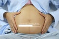 Belly of pregnant women and loading text in concept of time in c Royalty Free Stock Photo