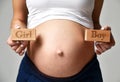 Belly of pregnant women with sign expectation girl or boy Royalty Free Stock Photo