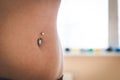 Belly of young woman with pierced navel Royalty Free Stock Photo