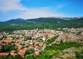 Belogradchick town in Bulgaria, surrounded by mountains and rock formations during spring, serene landscape taken from high rock Royalty Free Stock Photo