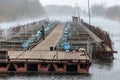 Beloozersk, Belarus, November 11, 2018: fish industry. man feeds and breeds fish. Autumn cold day. The fog spreads over the water