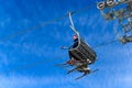 BELORETSK,RUSSIA, 13 APRIL 2019 - man skier goes on the ski lift against blue sky , closing the ski season in the Ural mountains Royalty Free Stock Photo